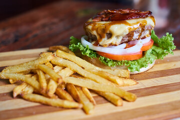 Gourmet Burgers With French Fries on a Wooden Table