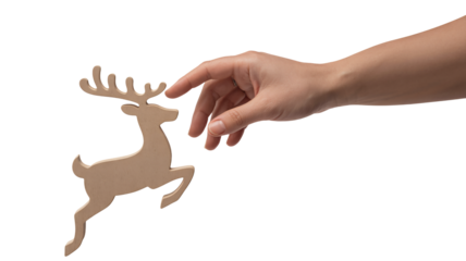 Gentle human hand reaches out to touch a small wooden reindeer cutout against a stark