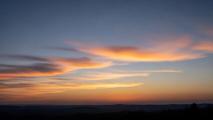 Fototapeta premium Vibrant Sunset Sky with Wispy Clouds and Gradient Hues.
