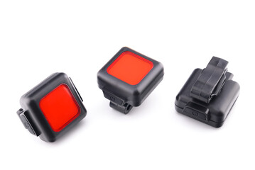 three red rear bicycle lights on white background