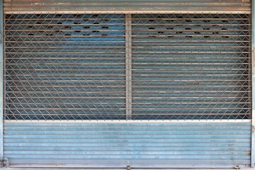 Old and dirty two roll up steel doors with padlocks pattern background