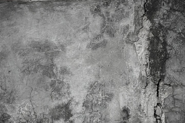 Grungy grey concrete wall with heavy vertical crack texture in black and white © Antler Tackle