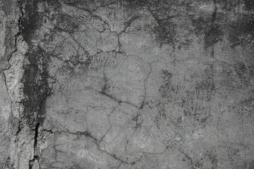Grungy grey concrete wall with heavy vertical crack texture in black and white © Antler Tackle