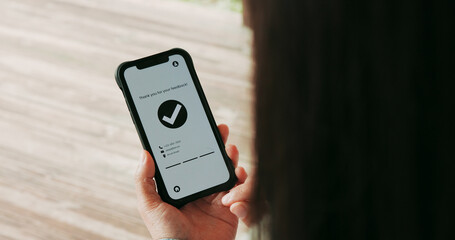Hands, woman and phone screen with tick approval for website feedback of online survey. Closeup, person and mobile with confirmation icon for rating, submitted message and user experience interaction