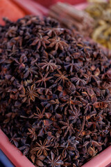 Close-up of a market display case filled with dried anise, which is often used to make tea, potpourri or natural remedies.