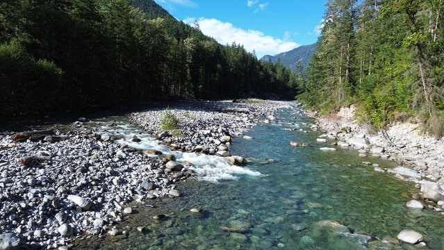 Scenic River Flowing Through Mountain Valley