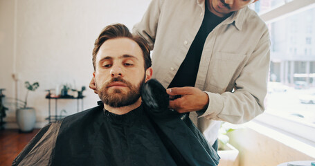 Hairdresser, barber and man with customer in chair for grooming, haircut and trim for beard service. Hair salon, appointment and people with tools for styling, shave and treatment in barbershop