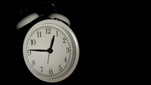Tme lapse video of a clock time passing over a day to night on black background.