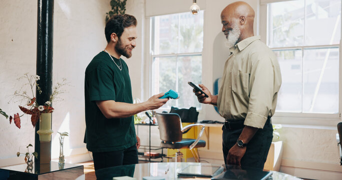 Men, hairdresser or customer with pos machine or phone for payment, banking or checkout in salon. Male people, barber or client with mobile smartphone for tap to pay or wireless transaction in parlor