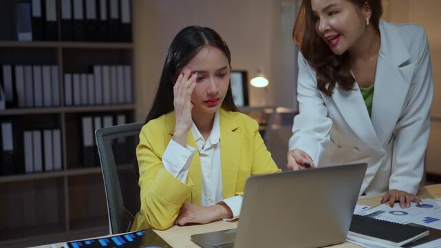Frustrated young female employee feeling overwhelmed and stressed while her angry boss yells at her for making a mistake at work