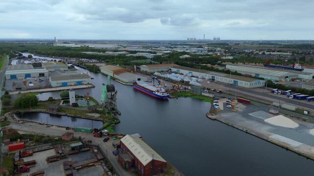 Expansive aerial drone flyover of Goole industrial port showing cargo ships, dock cranes, warehouses, and heavy plant machinery across Yorkshire&rsquo;s busy maritime hub