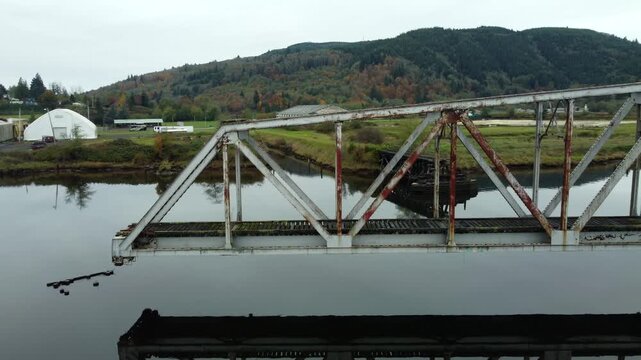 US, WA, Raymond, 2025-10-28 - Drone view of the abandoned train trestle rotating bridge on the Willapa River