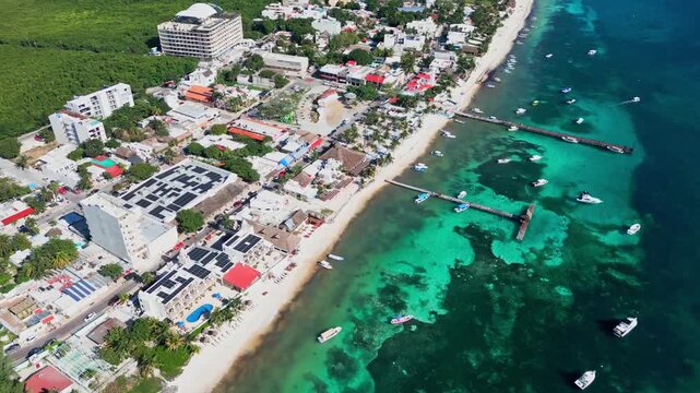 Aerial view of Puerto Morelos beachside, vibrant town by turquoise sea