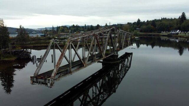US, WA, Raymond, 2025-10-28 - Drone view of the abandoned train trestle rotating bridge on the Willapa River