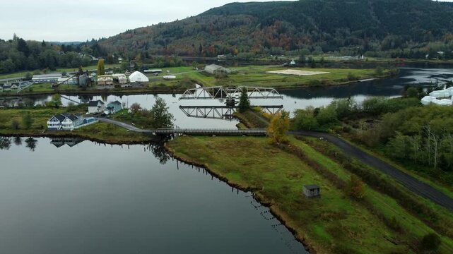 US, WA, Raymond, 2025-10-28 - Drone view of the abandoned train trestle rotating bridge on the Willapa River