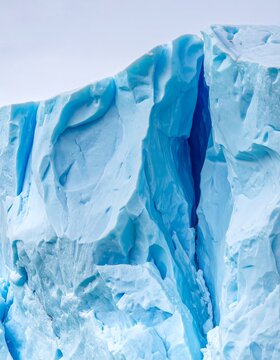 Close-up of a blue iceberg with textured, icy surfaces