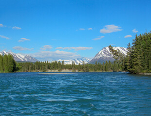 Beautiful View of Kenai River in Alaska with snow capped mountains on the background.