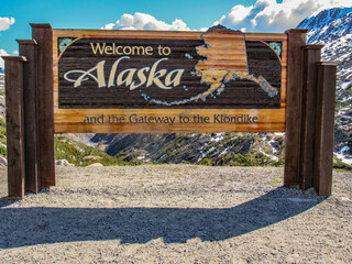 The Welcome to Alaska and the Gateway to the Klondike sign.