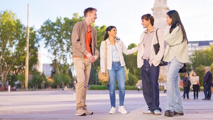 Diverse friends group having an inclusive conversation outdoors in city