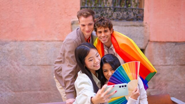 Diverse group taking selfie celebrating inclusion outdoors - Powered by Adobe