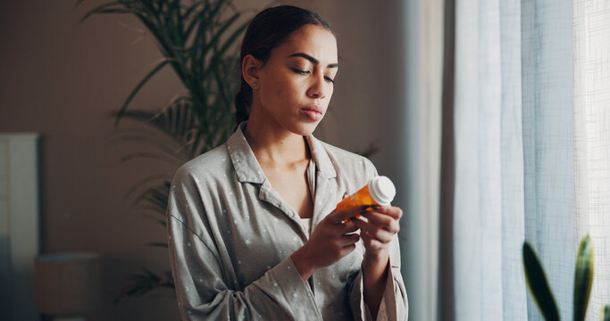 Home, woman and check pills label in morning for prescription, side effects and dosage info. Apartment, person and reading medication instructions for health benefits, ingredients and tablets warning