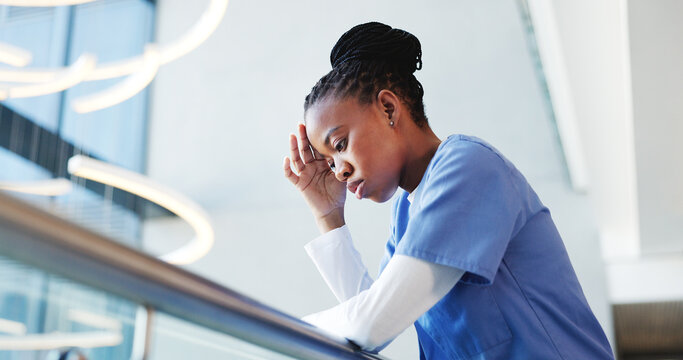 Medical, low angle or nurse in hospital with thinking, patient loss or stress in surgery result. Healthcare, reflection or black woman in clinic with guilt, disappointment and worry in emergency risk