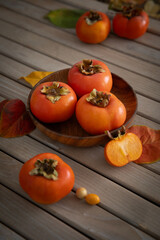 fresh Persimmons on wooden table