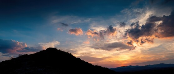 Sunset landscape with silhouette of mountain