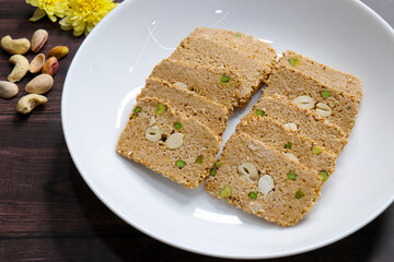 Til gajak, a traditional Indian winter sweet made with sesame seeds, jaggery, ghee, and dryfruits. Crunchy til chikki festive treat for Makar Sankranti. Tilgul. sesame candy. Copy Space. Winter food.