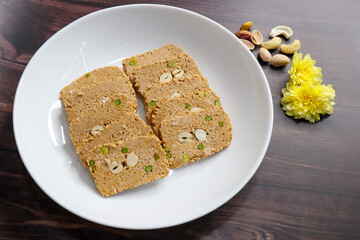 Til gajak, a traditional Indian winter sweet made with sesame seeds, jaggery, ghee, and dryfruits. Crunchy til chikki festive treat for Makar Sankranti. Tilgul. sesame candy. Copy Space. Winter food.
