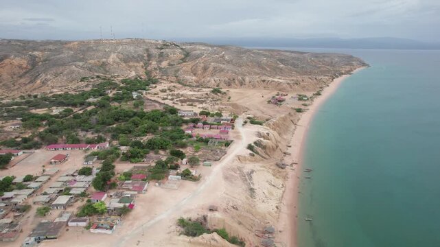 Scenic Caribbean Coastline with Desert Hills and Village Araya