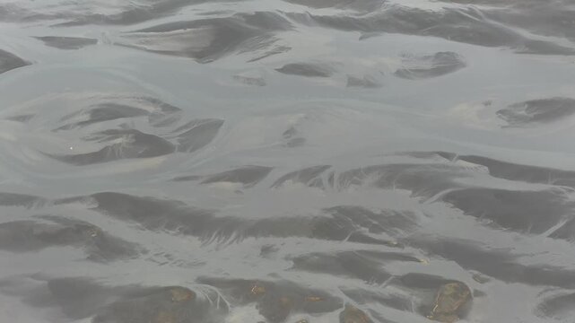 Wind eroded snow bedforms in Iceland, where sastrugi‑like ridges and ripples produced by aeolian transport and sublimation form elongated microdunes aligned with the prevailing wind direction.