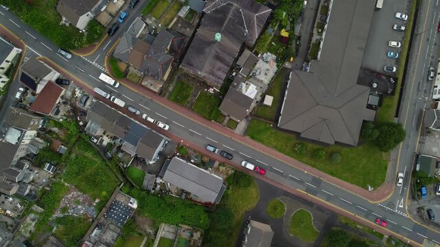 Top-down drone view of Skewen village and Neath Abbey suburb border area with local traffic movement and parking cars, Wales, United Kingdom, UK