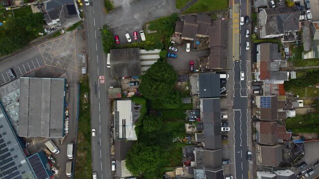 Top-down drone fly over Neath Abbey suburb block with houses, yards and local roads, Wales, United Kingdom, UK
