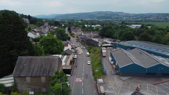 Drone fly over Hen Heol road with industrial district and warehouses of Neath Abbey suburb area, Wales, United Kingdom, UK