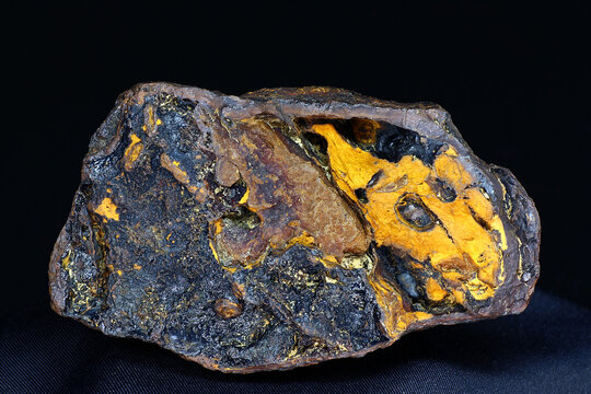 Striking yellow and black goethite limonite specimen, a vibrant mineral sample from Russia's Kaluga region on a dark backdrop