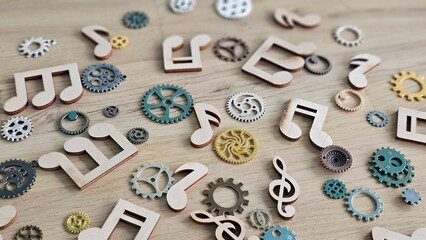 Colorful music notes and gears scattered on a wooden surface in a creative arrangement concept