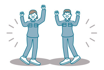 嬉しそうにガッツポーズをする作業着の女性たち