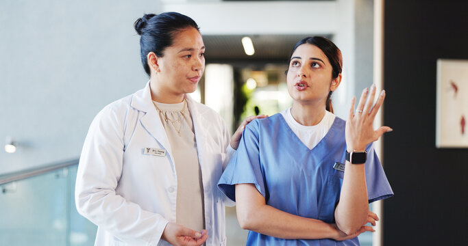 People, doctors and talking with concern in hospital for staff shortage, treatment delay and mistake. Women, nurse and discussion of medical issues, healthcare malpractice and comfort for reassurance