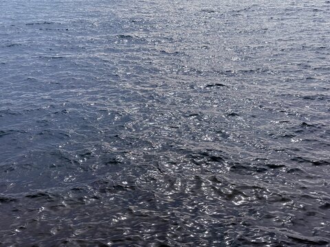 Glittering sea water surface background.