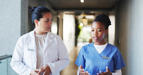 Doctor, nurse and walking with discussion in clinic for medical opinion, treatment plan and advice....