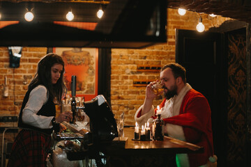 Santa claus drinking whiskey at a dimly lit bar