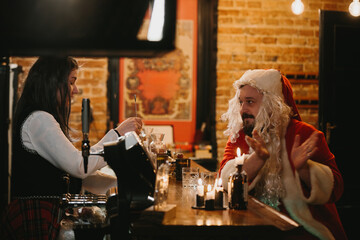 Santa claus taking a break at bar
