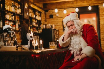 Santa claus feeling burnout at a bar table