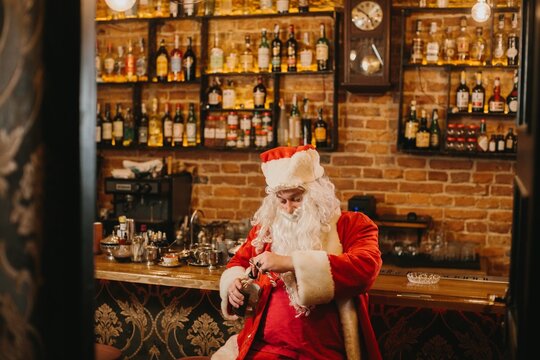 Santa claus pouring drink at a bar - Powered by Adobe