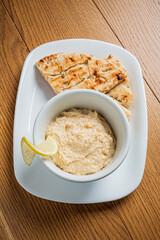 Creamy hummus paired with freshly baked pita bread invites a delightful taste experience