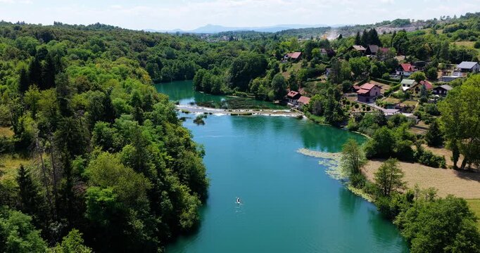 Holiday Accommodation Houses Along The Mrežnica River In Donji Zvečaj, Duga Resa, Croatia. Aerial Shot