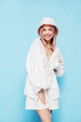 Young beautiful smiling blond female in trendy summer  white dress clothes. Carefree woman posing...