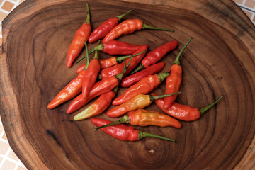 Fresh Red Cayenne pepper on a wooden cutting board, Stack of vegetables. 