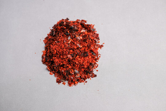 Macro Close-up of Vibrant Red Crushed Paprika Spice Flakes (Capsicum annuum) Used for Culinary Flavoring and Natural Color